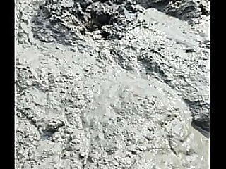 Solo Male Wading Barefoot in Lakebed of Mud