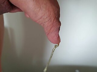 Man peeing in his long foreskin