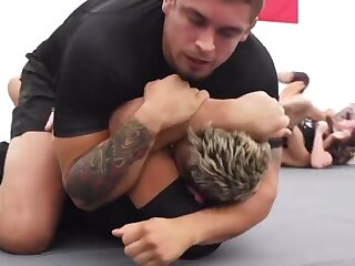 A wrestler coach wipes up the floor