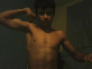 Guy flexing for the camera shirtless.