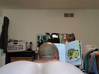 Hot butt in bed reads a book.