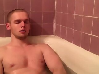 Cute guy wanking in a bathtub