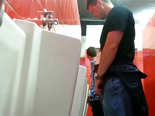 Small dicked guy taking a peek a bigger dick at urinal