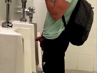 Uncut dick and balls out, pissing at urinal