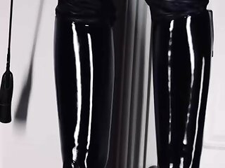 Leather Gay Master showing off his shiny boots