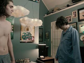 Young guy with long hair texting from the bathtub