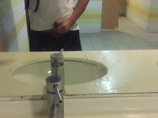A student received a helping hand from his friend in the bus station bathroom.