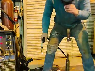 Title says it, this hot bull shows off some welding while ... a heavy chunk of metal from his balls and cums.